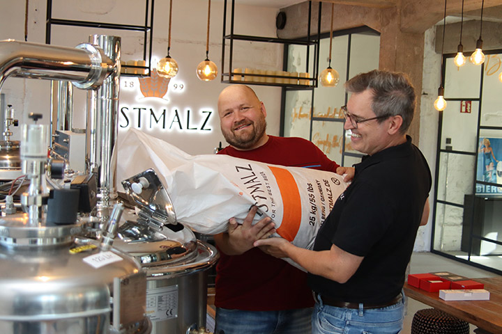 2025 BestBrewChallenge winner Tomas Sirtautas pouring grain in a kettle.