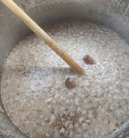 Chestnut mash being stirred.
