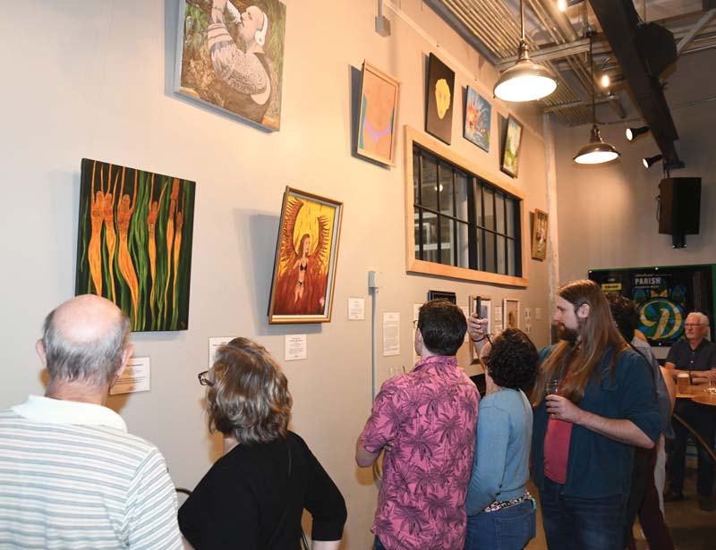 people enjoying the Museum of Bad Art at the Dorchester Brewing Co.