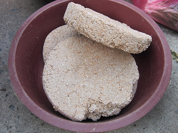 Dry nuruk disks used to make makgeolli in a dish.