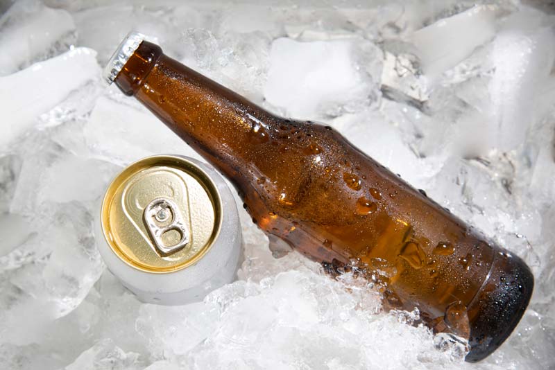 beer bottle and can on ice