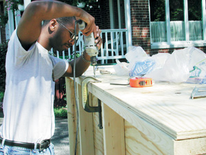 Man assembles wood framing.
